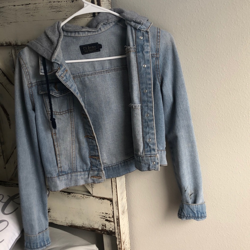 a denim jacket with a grey hood